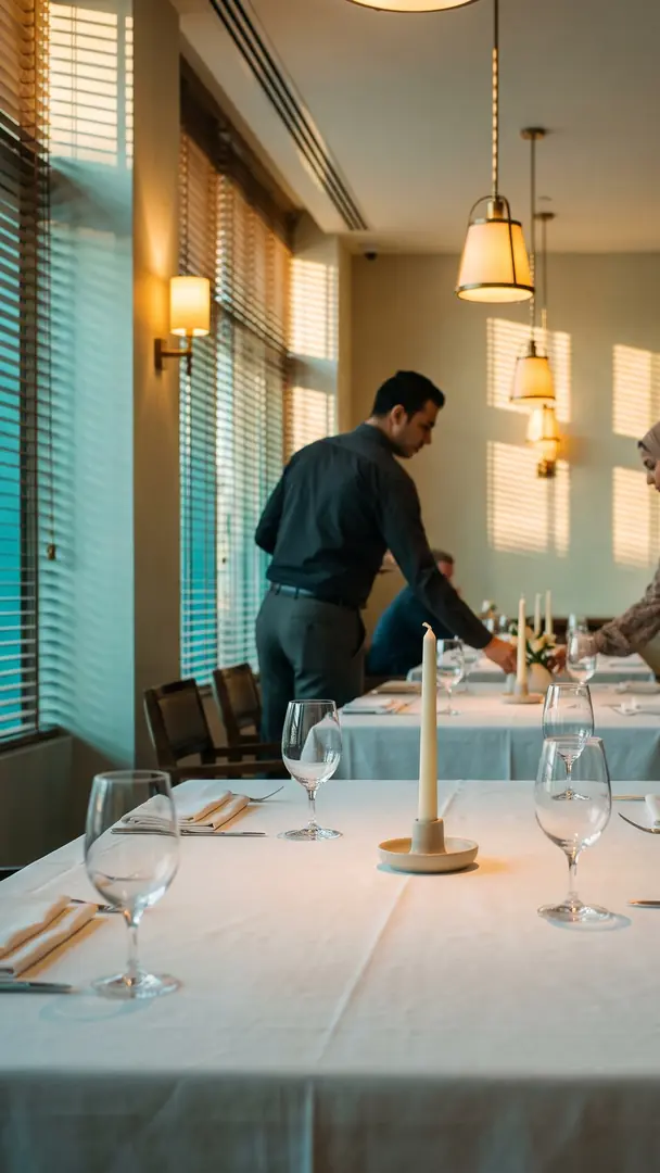 A dining room set for service, tables laid and still empty